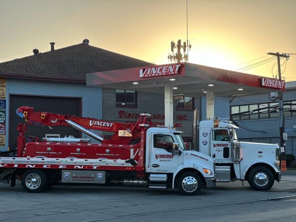 Vincent towing truck in front of the garage